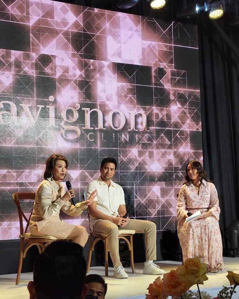A panel discussion on stage at a corporate event