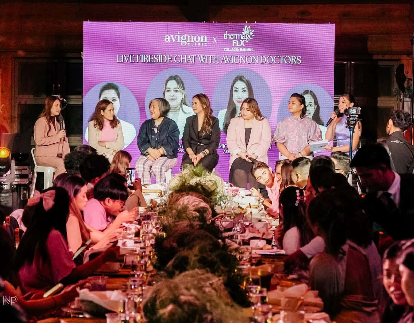 A fireside chat, seen over the guests' tables