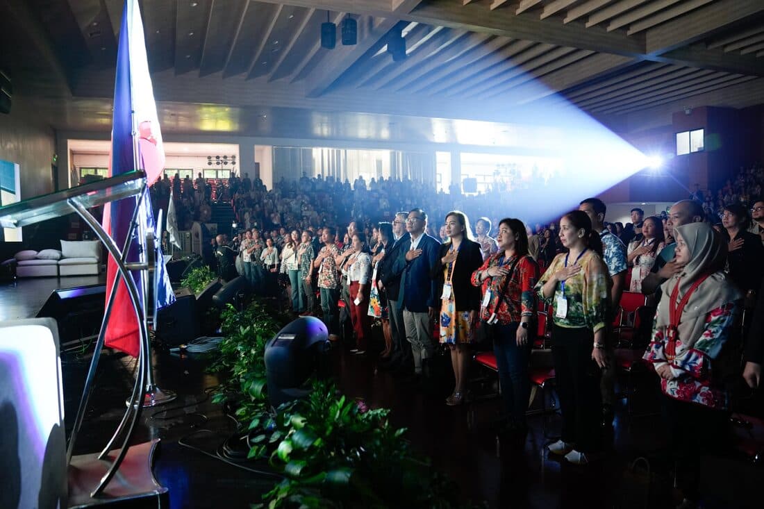 Delegates standing for the opening