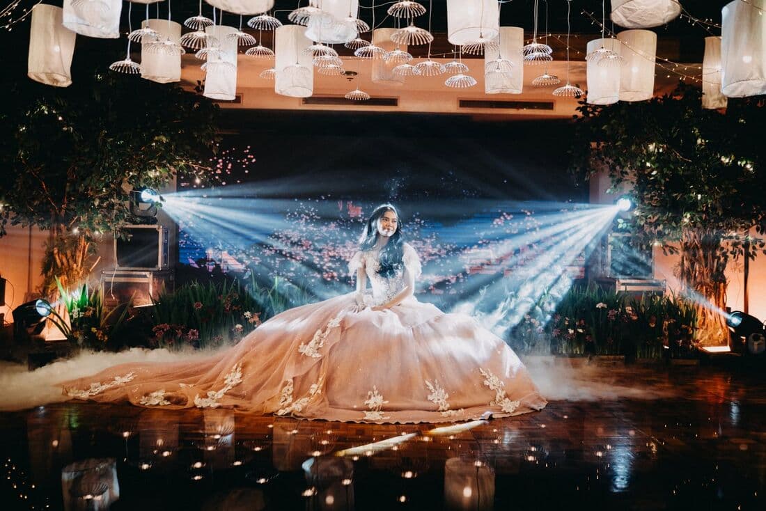 A debutante on stage in a full gown