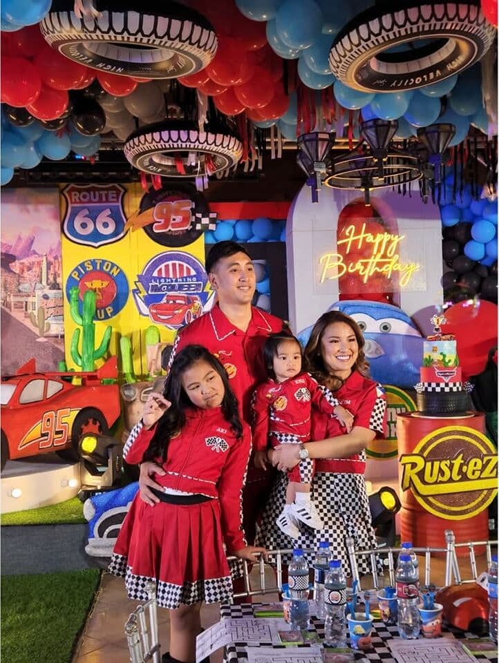 A family at a Cars-themed birthday party