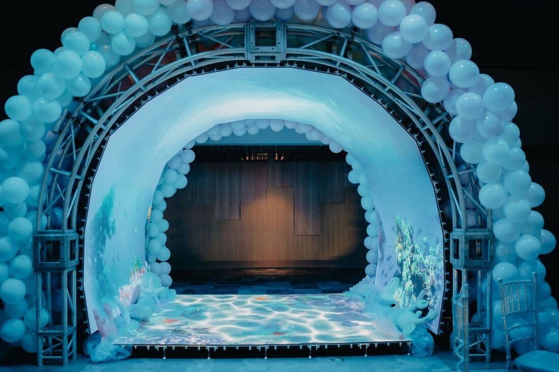 A balloon arch framing a party stage