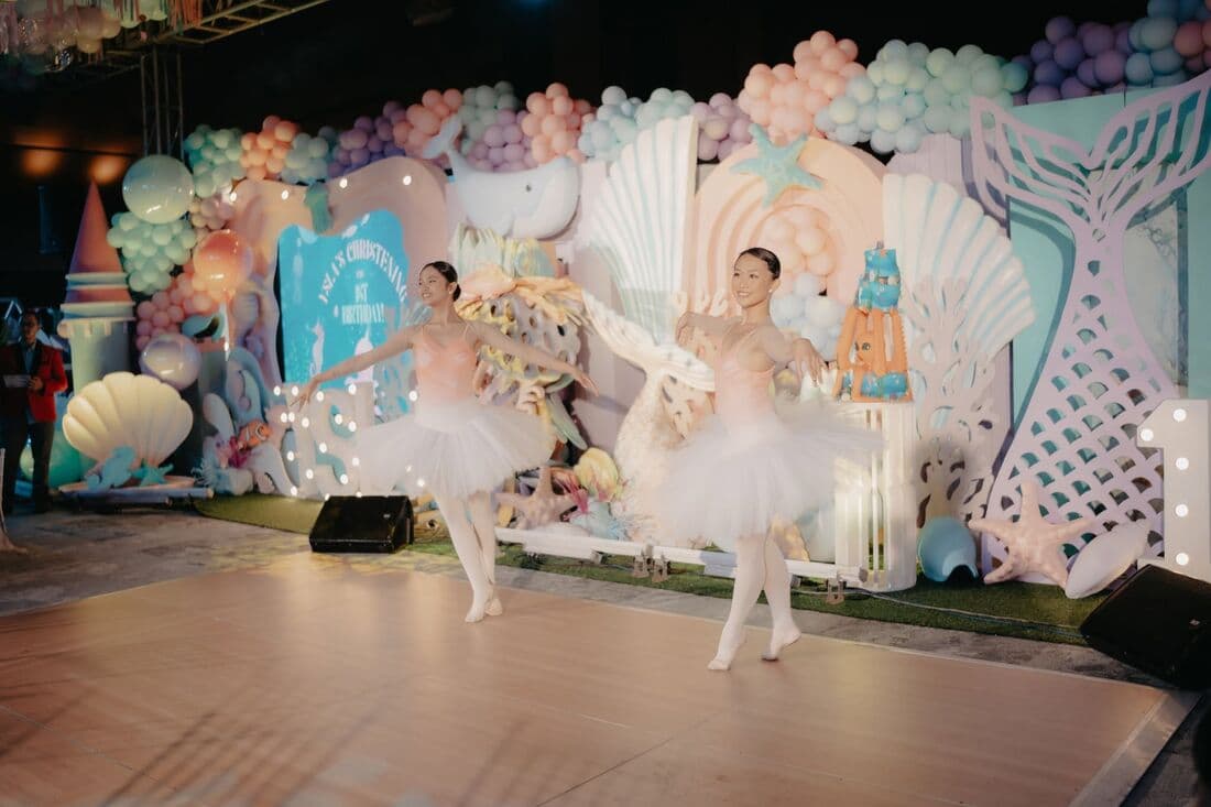 A little girl performing on a themed party stage