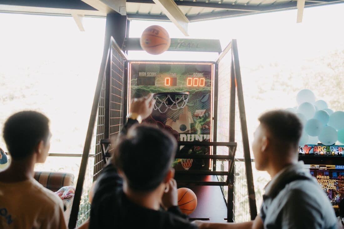 Children at an arcade basketball game