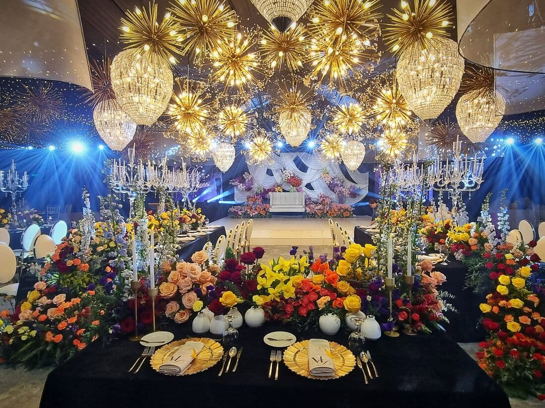 A reception hall under hanging gold paper lanterns