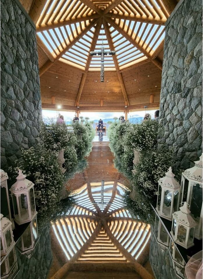 A lantern-lined aisle in a timber chapel