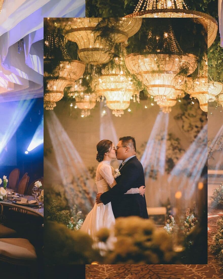 The couple dancing beneath chandeliers