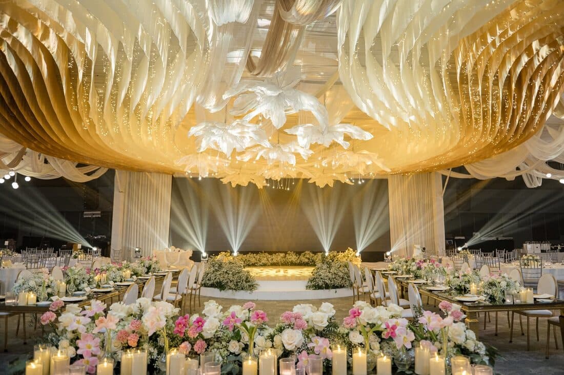 A gold canopy over a candlelit banquet