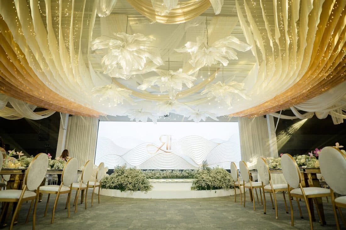 The reception hall beneath a draped gold ceiling