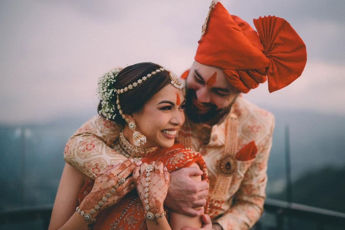A couple in red and gold at their Indian wedding