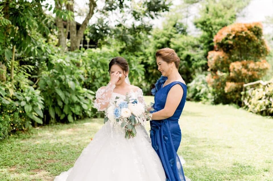 A bride with her mother in a garden
