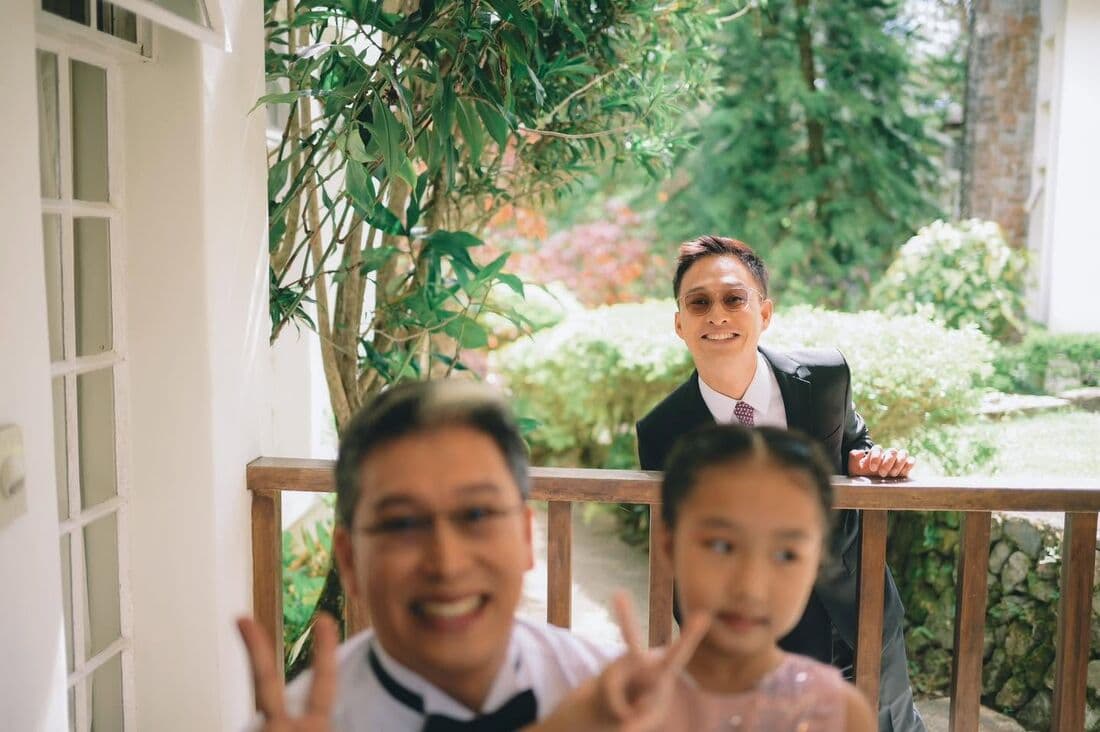 Family and guests laughing at a table
