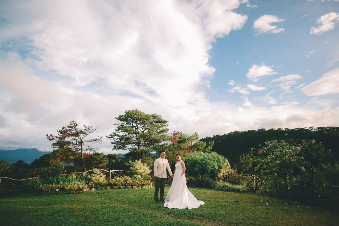 A couple on a ridge with the mountains behind