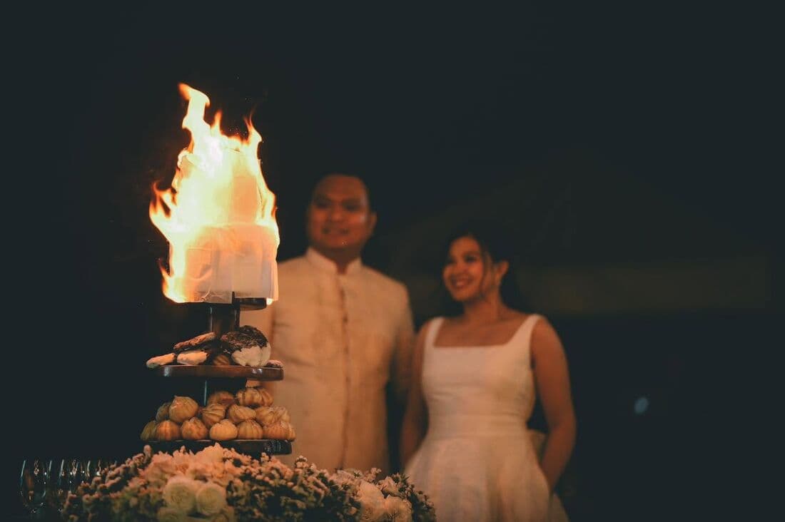 A couple beside a bonfire at night