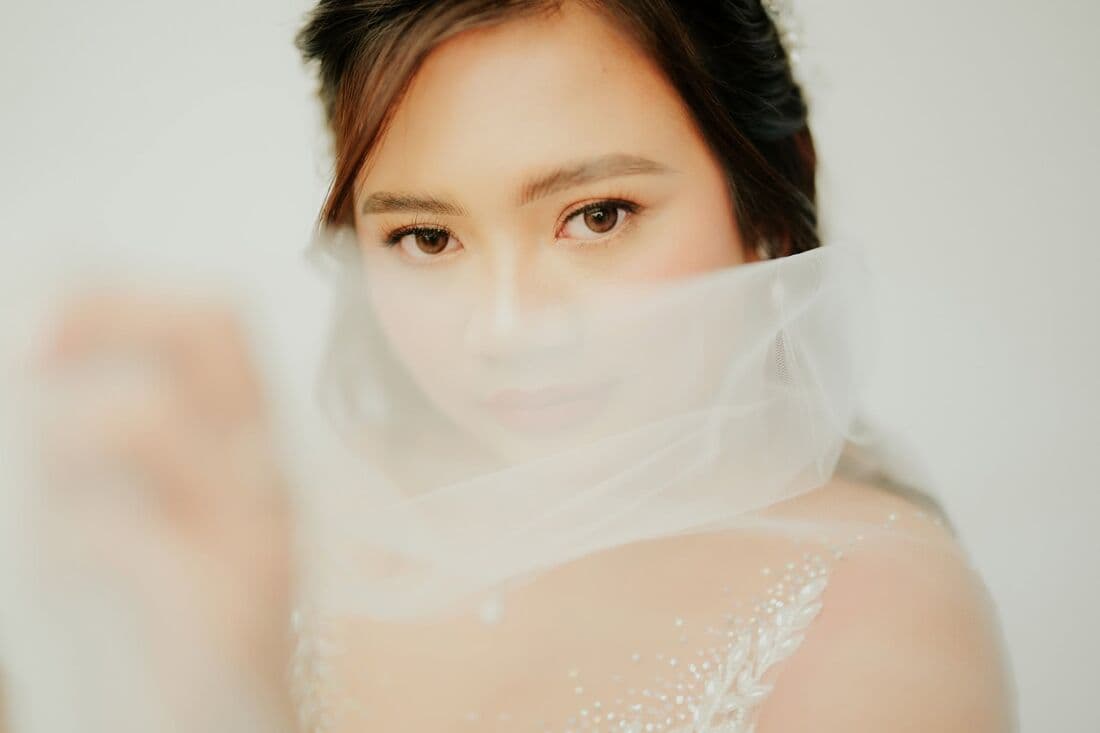A bride's face behind her veil