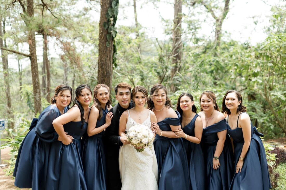 Bridesmaids in navy holding bouquets