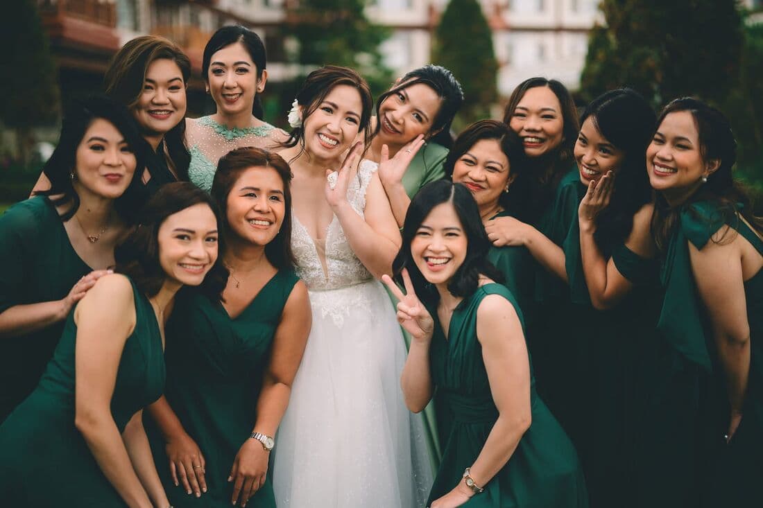 Bridesmaids in green, laughing