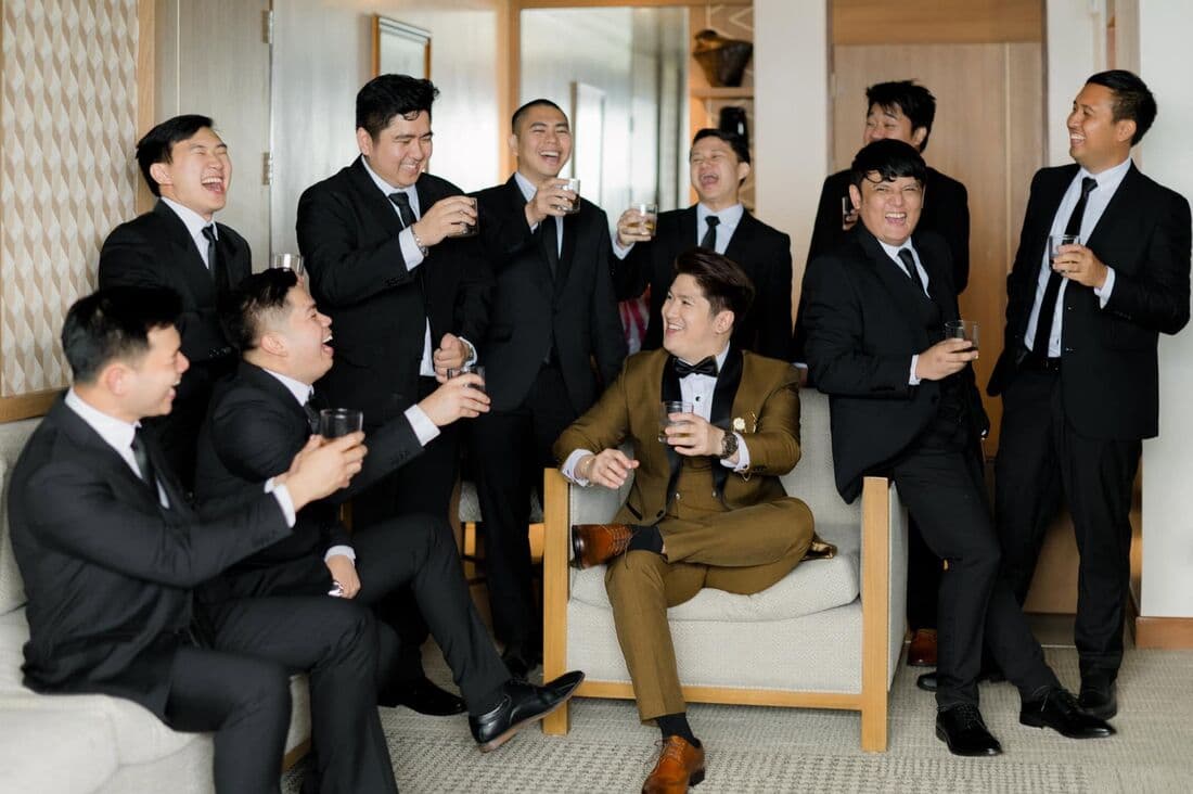 Groomsmen in black tie in a lounge