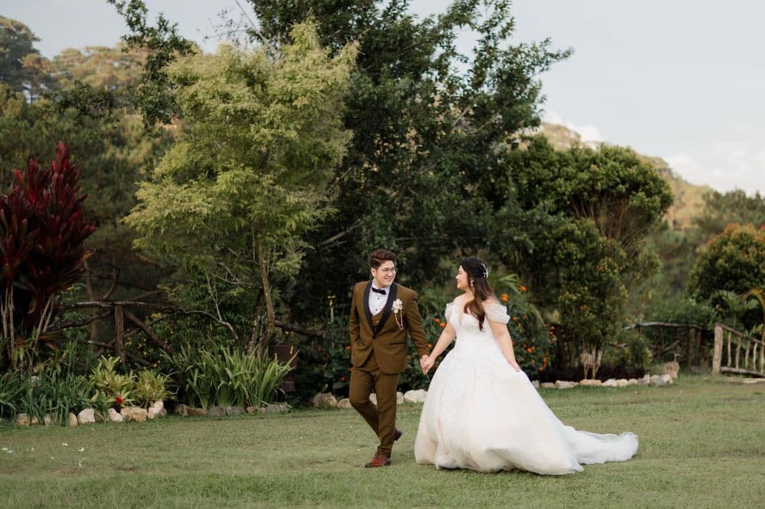 A couple running across a field