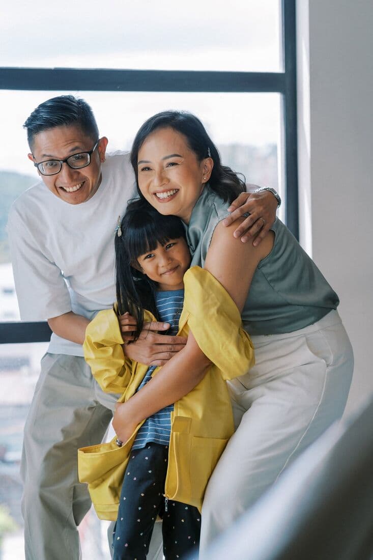 A family holding each other, laughing