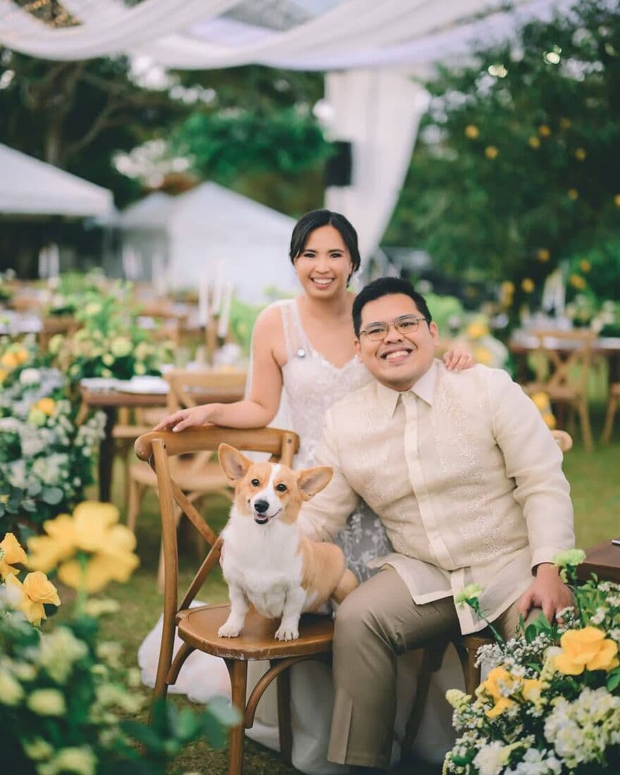 A couple seated with their dog