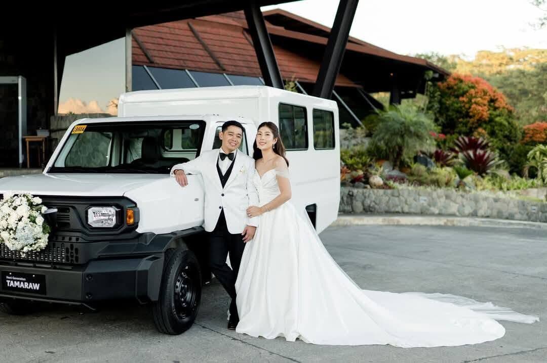 A couple beside a white truck