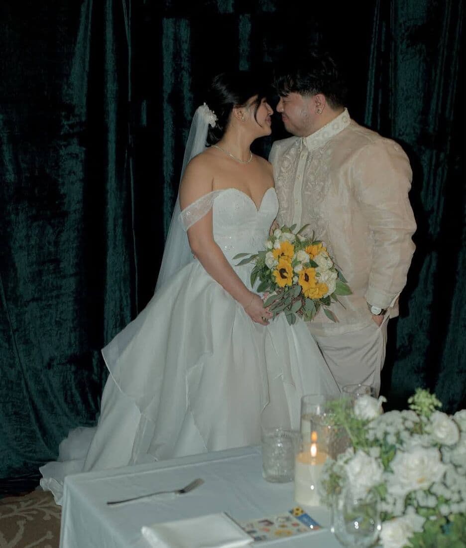 A couple kissing at their table
